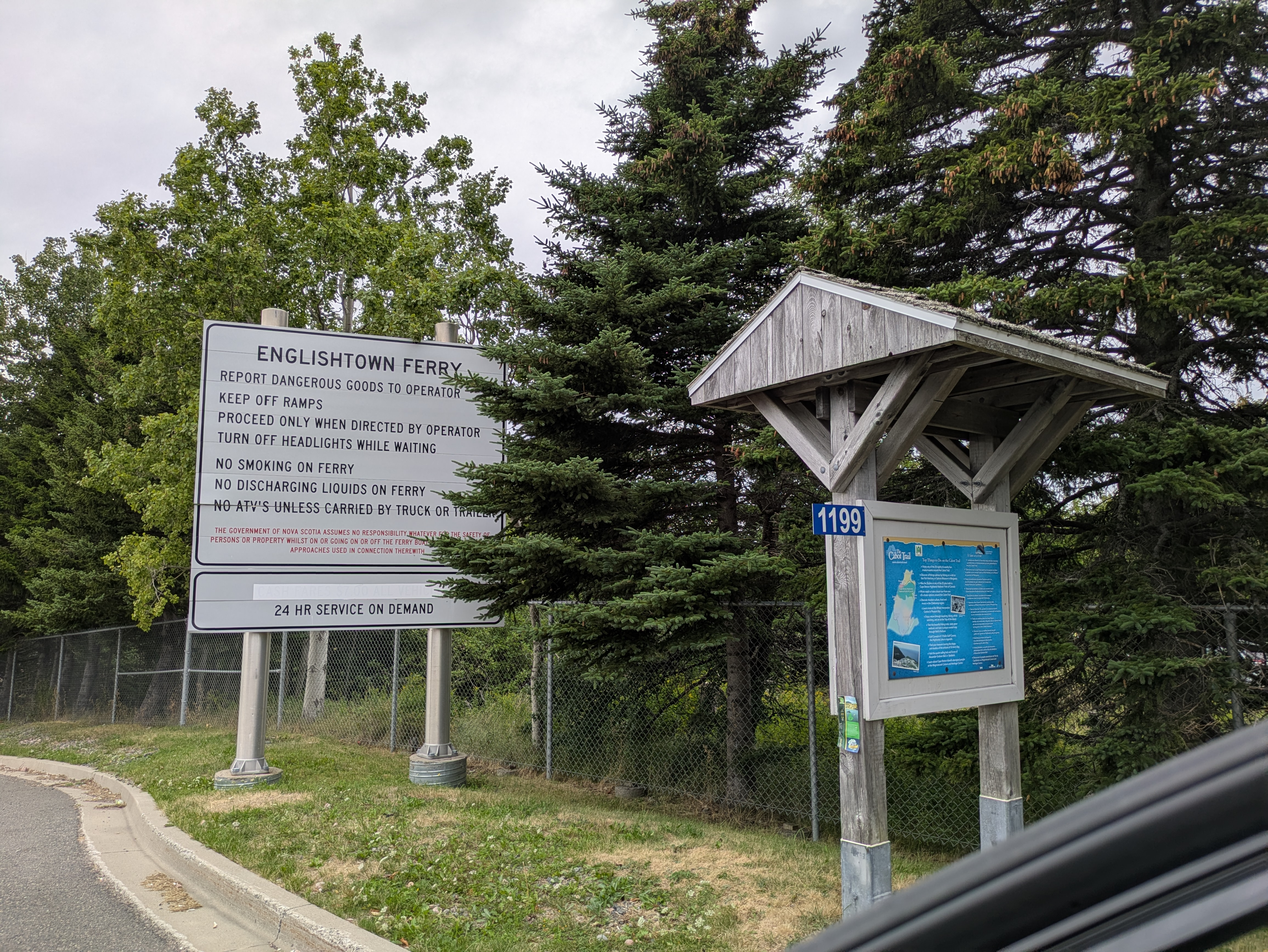 Ferry rules sign and vehicle lineup at Englishtown terminal - safety guidelines